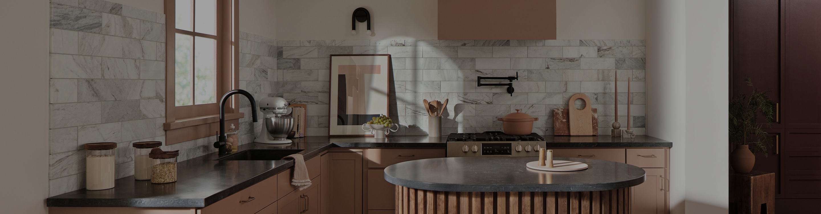 kitchen with terracotta cabinetry and gray backsplash tile